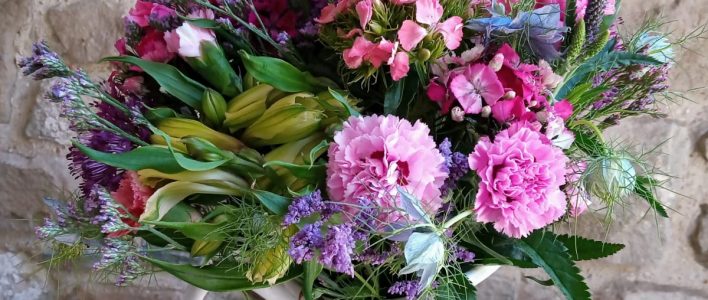 A 'Cornish Flowers - Mixed Bunch' featuring Scented Pinks, Alstroemeria, Statice and Nigella. Fresh Cut flowers. Vase not included.