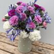 A green spotty jug of Scented Pinks and Agapanthus